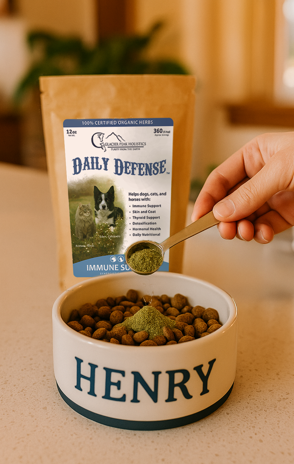 A hand scoops organic herb powder into a dog bowl, next to a bag of Daily Defense immune support.