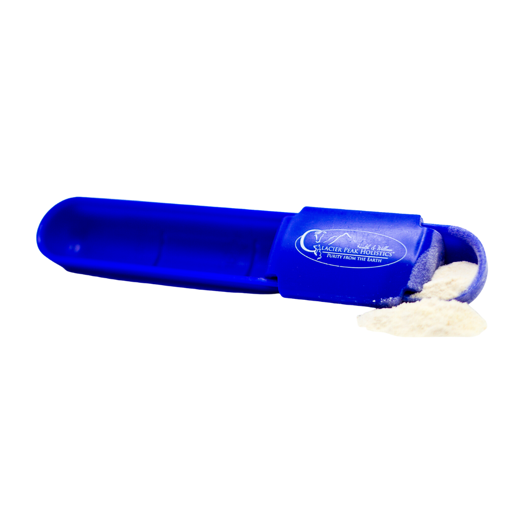 A blue measuring apoon, designed to dispense ProBio Complete for dogs and cats, lies on its side with powder spilling out.