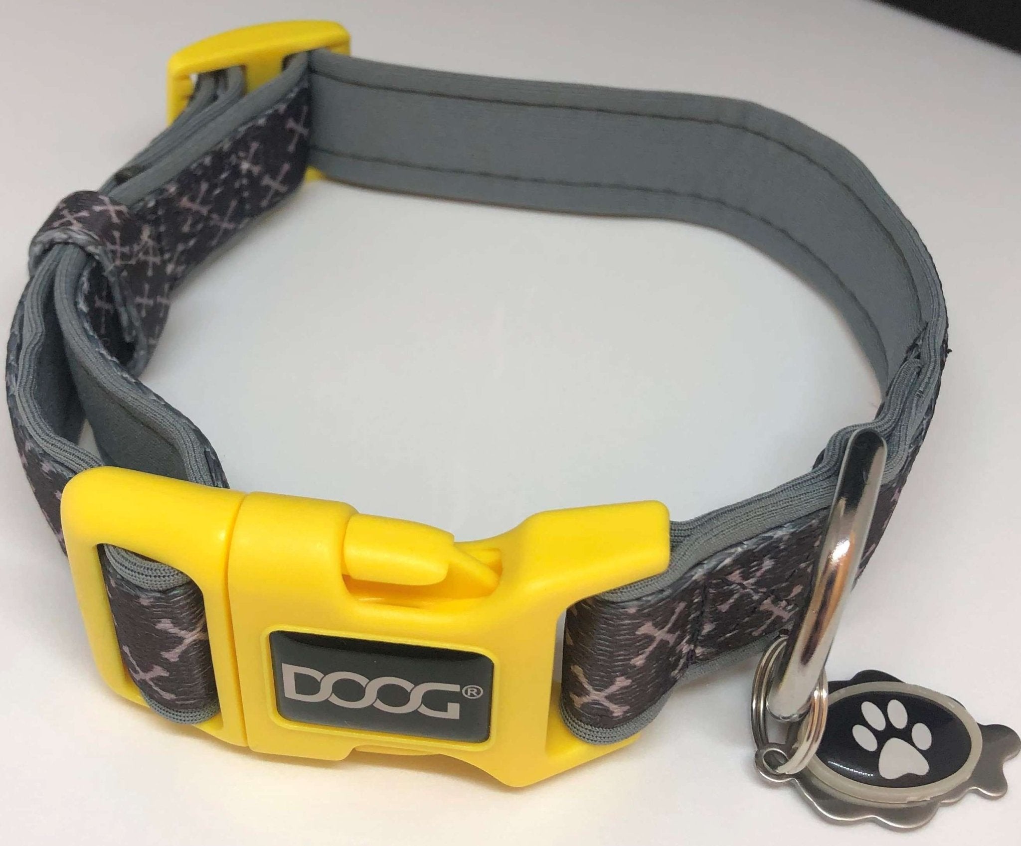 A grey dog collar with a yellow buckle and EMF gaurd