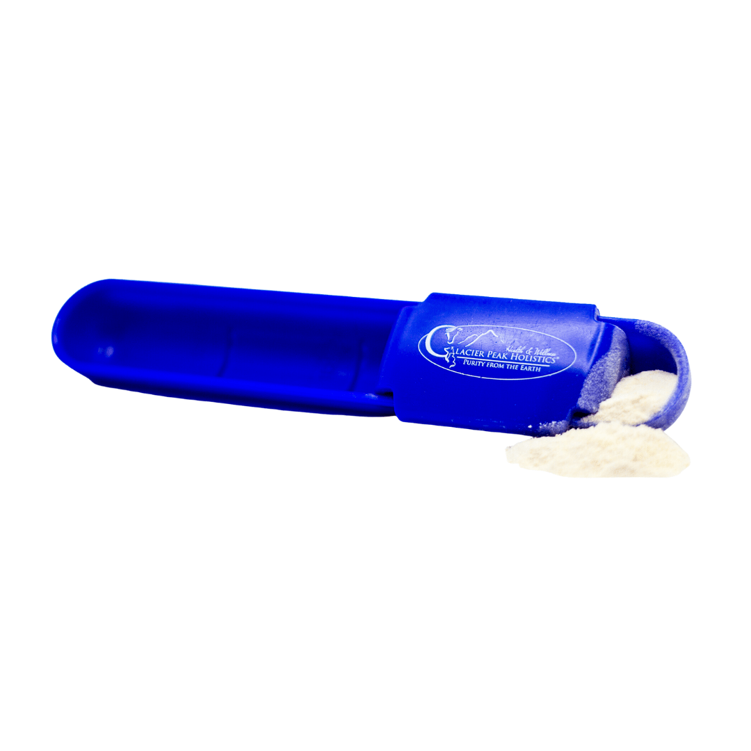 A blue measuring apoon, designed to dispense ProBio Complete for dogs and cats, lies on its side with powder spilling out.